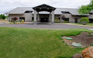 Exterior view of a covered carpool area in front of a building